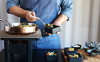 Chef serving portions of food